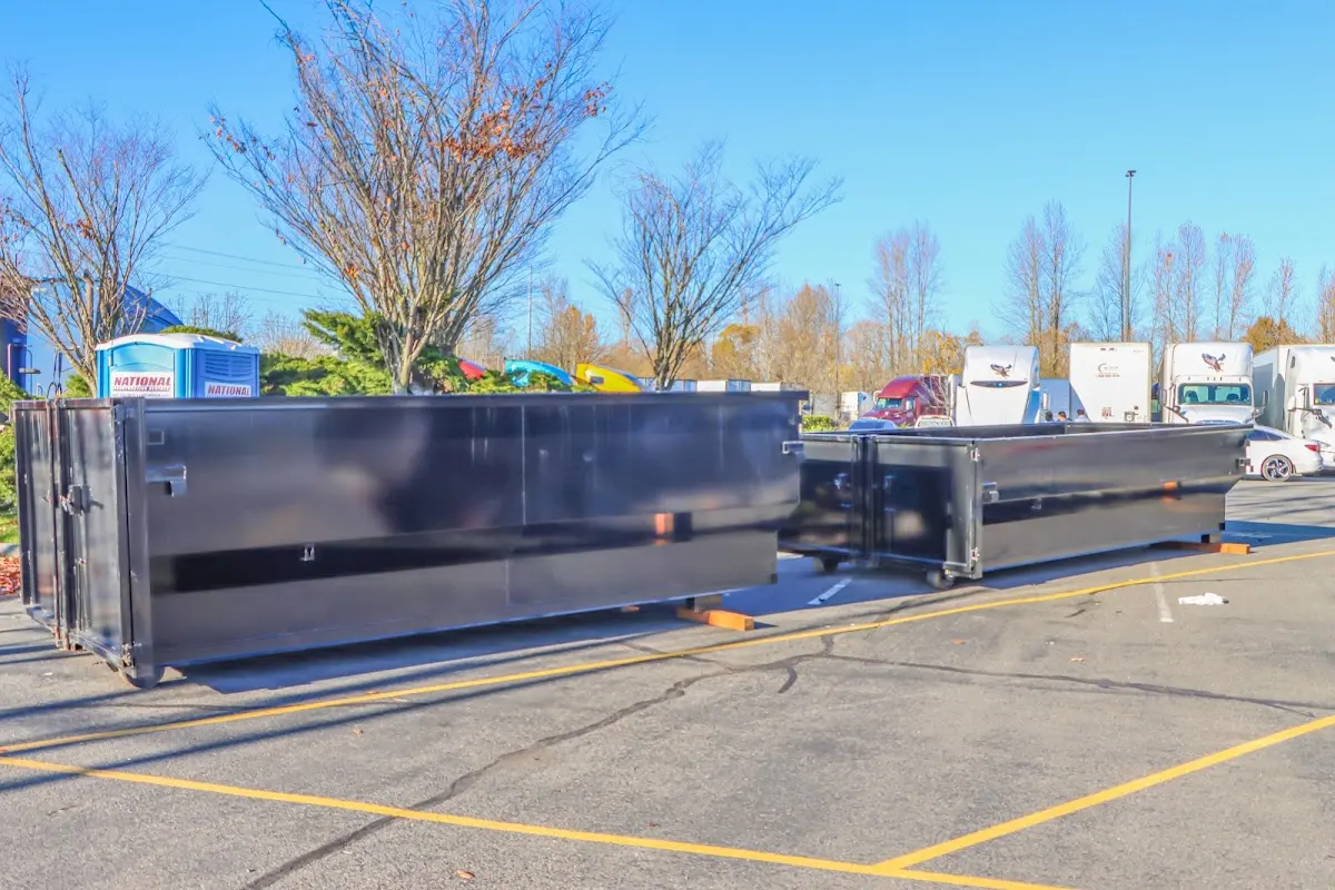 Professional dumpster rental service with roll-off container on residential driveway in Kentwood